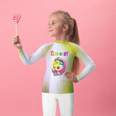 Child wearing Magical Unicorn Dreams Kids Rash Guard on the beach.