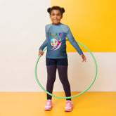 Child wearing Mermaid Lagoon rash guard at the beach.