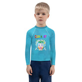 Child wearing Fairy Godmother rash guard at the beach