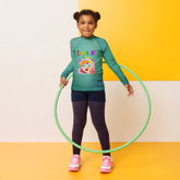 Kid wearing Snowy Wonderland rash guard on the beach