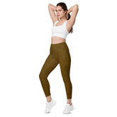 Woman wearing earthy foliage leaf texture leggings, showcasing natural style and practical pockets.