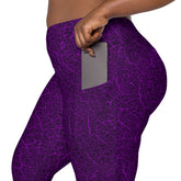 Woman on a serene woodland walk wearing leaf texture leggings with practical pockets.