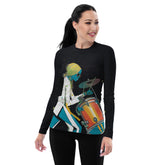 Rhythmic Waves women's rash guard in action on a surfboard.