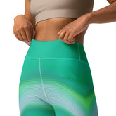 Engaging in a dynamic yoga flow wearing Vibrant Wave Wavy Gradient Leggings.