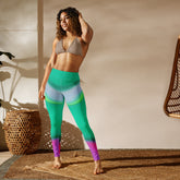 Perfecting a yoga pose by the sea in Oceanic Flow Wavy Gradient Yoga Leggings.