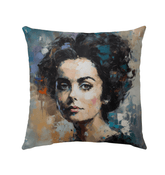 Ambient Landscapes Outdoor Pillow on a patio chair, showcasing its vibrant design.