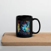 Black glossy mug by Creative Canvas on wooden table.