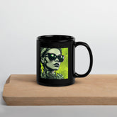 Black glossy mug with colorful doodle art designs.