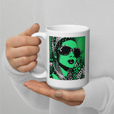 Inked Ideation white glossy coffee mug on a wooden table.