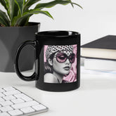 Inked Impressions II black glossy coffee mug on a wooden table.