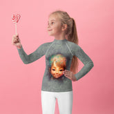 Child wearing Magical Cherubs Glimpse Rash Guard at the beach.