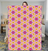 Plush Southwestern patterned sherpa blanket on a cozy couch.