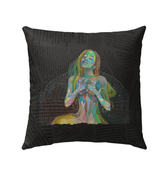 Colorful butterfly design on outdoor pillow amidst garden setting