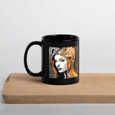 Painted Permanence black glossy coffee mug on table.