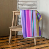 Coastal Horizon Bath Towel displayed in a serene bathroom setting, showcasing its plush texture and vibrant colors.