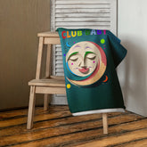 Spellbound Garden Premium Bath Towel displayed on a wooden rack