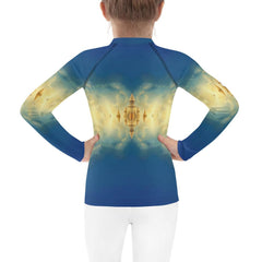 Back view of the CB3-121 Kids Rash Guard on a child at the beach