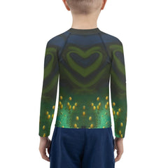Side profile of a child wearing CB3-81 Rash Guard at the beach.