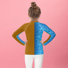 Child wearing colorful abstract shapes rash guard