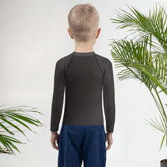 Kid's rash guard with colorful forest print and UV protection.
