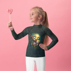 Child wearing CB3-76 rash guard at the beach