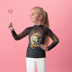 Child wearing CB3-107 kids rash guard while playing on the beach