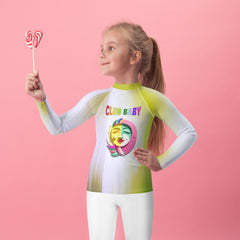 Child wearing Magical Unicorn Dreams Kids Rash Guard on the beach.
