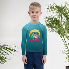 Child wearing Pirate's Treasure rash guard at the beach
