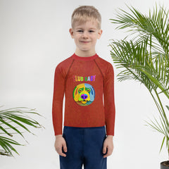 Child wearing Magic Carpet Ride Kids Rash Guard at the beach
