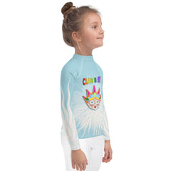 Child wearing Cinderella's Ball rash guard at the beach
