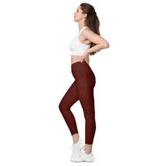 Fitness fashion meets nature: Woman stretching in Earthy Foliage Crossover Leggings, highlighting their supportive waistband and vibrant print.