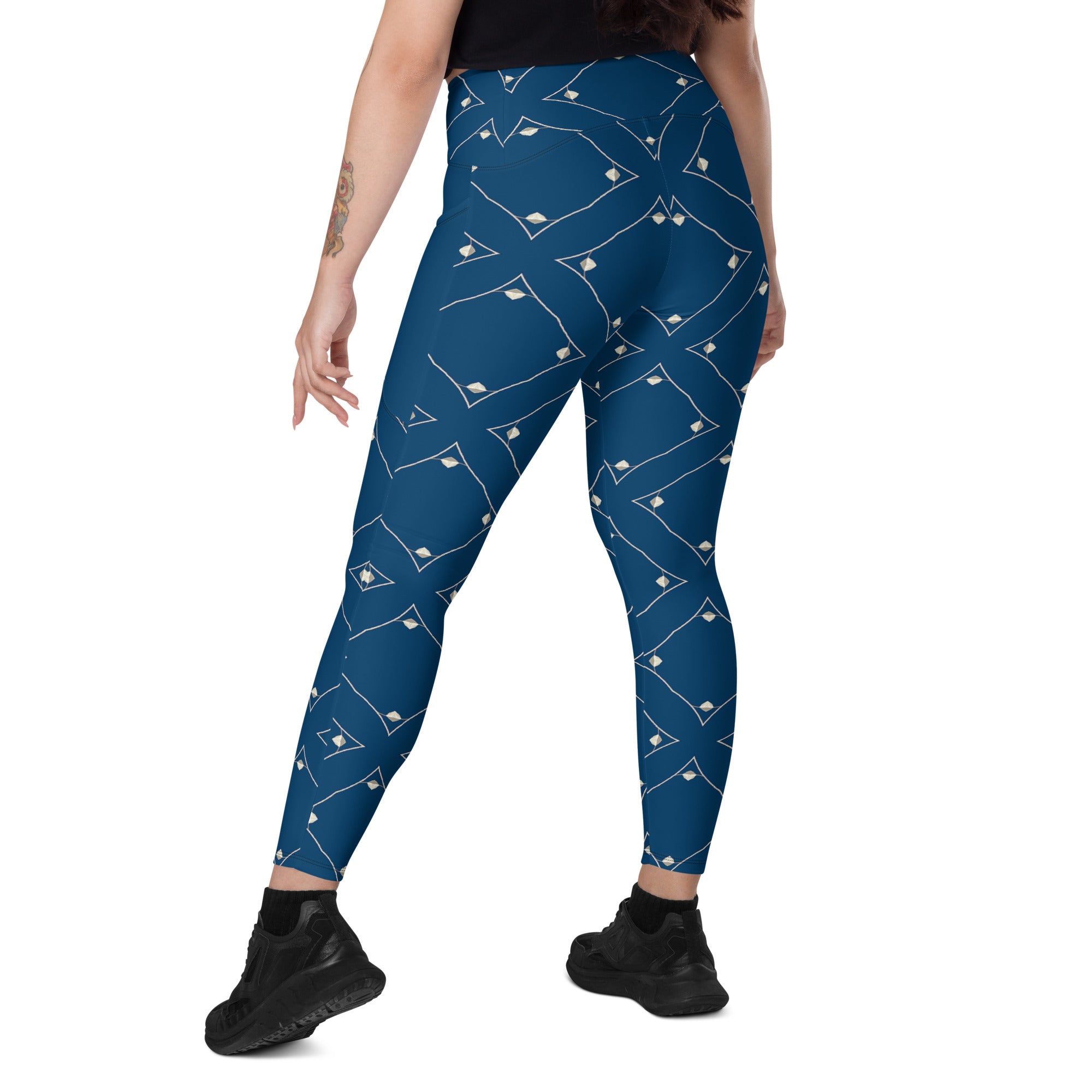 Stylish woman wearing Abstract Aura leggings with crossover waistband.