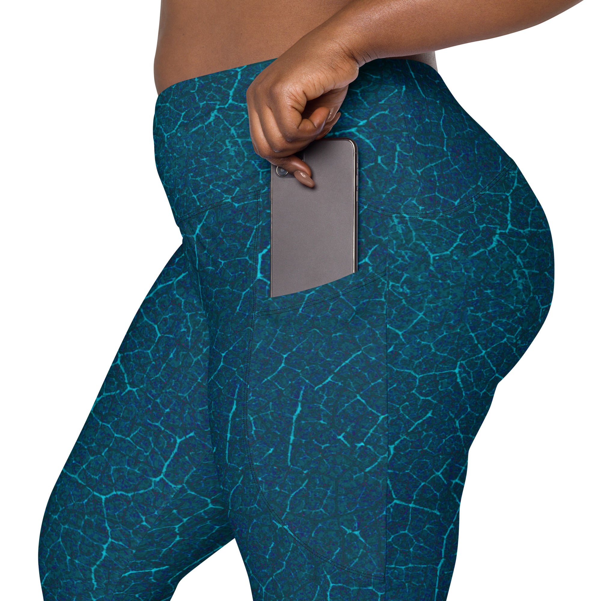 Woman wearing Tropical Oasis Leggings, highlighting the crossover waistband and vibrant tropical print.