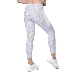Stylish crossover leggings with Cosmic Chaos design and practical pockets.
