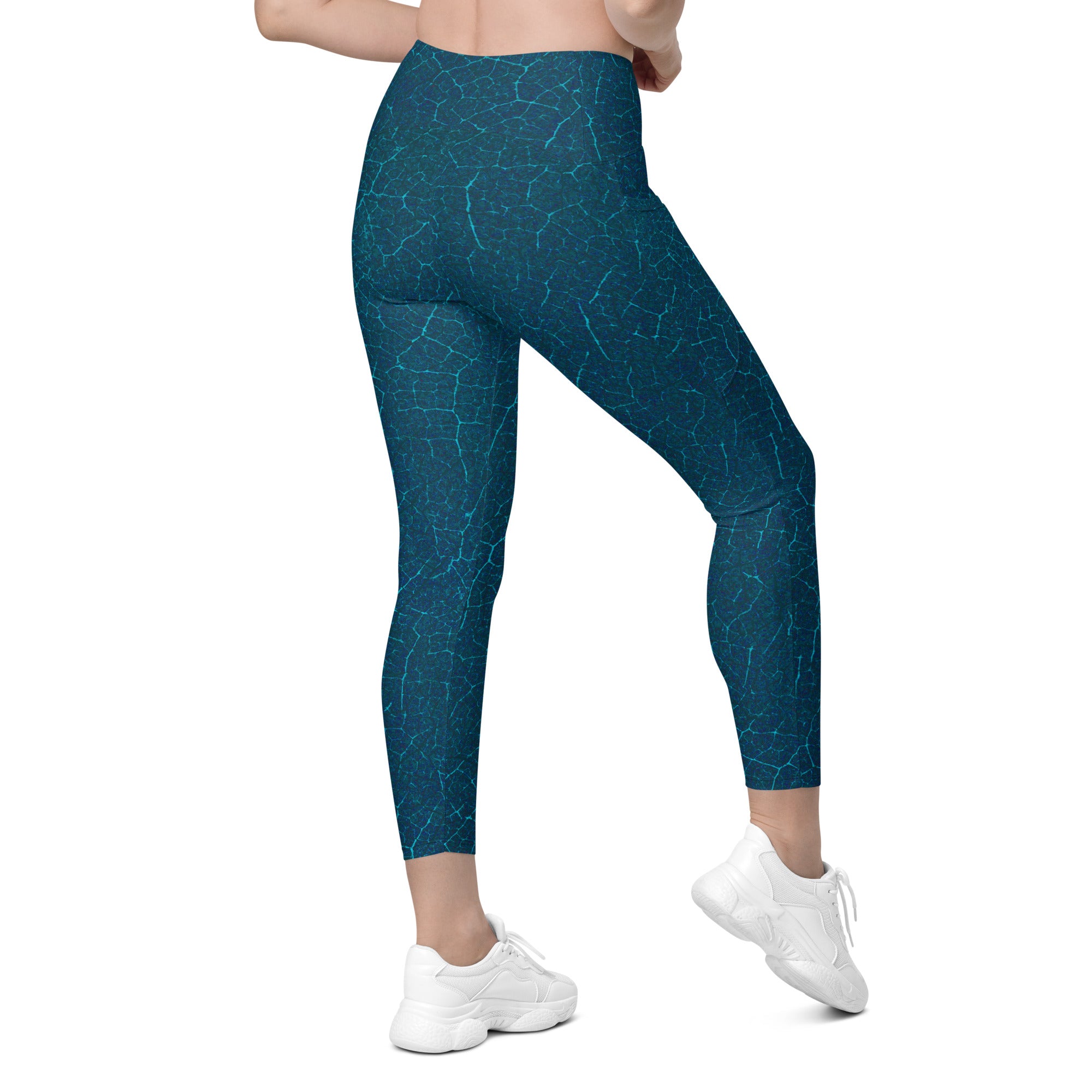 Tropical Oasis Crossover Leggings laid flat, showcasing the detailed tropical design and unique waist feature.