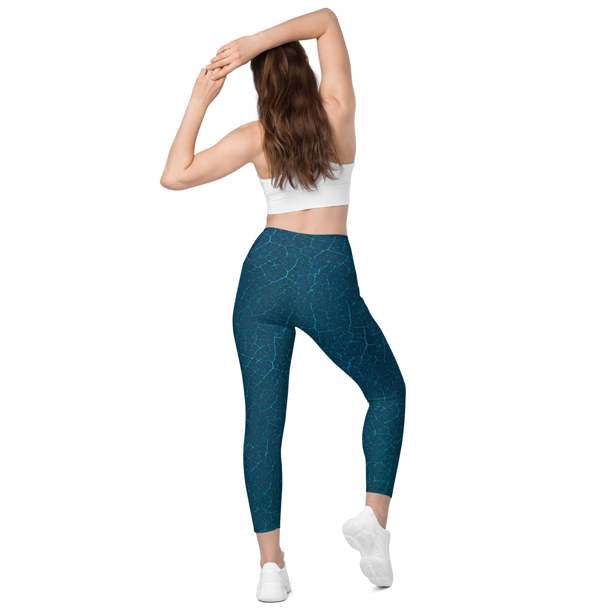 Active wear meets wilderness with leaf-textured leggings, designed with pockets for the outdoor explorer.