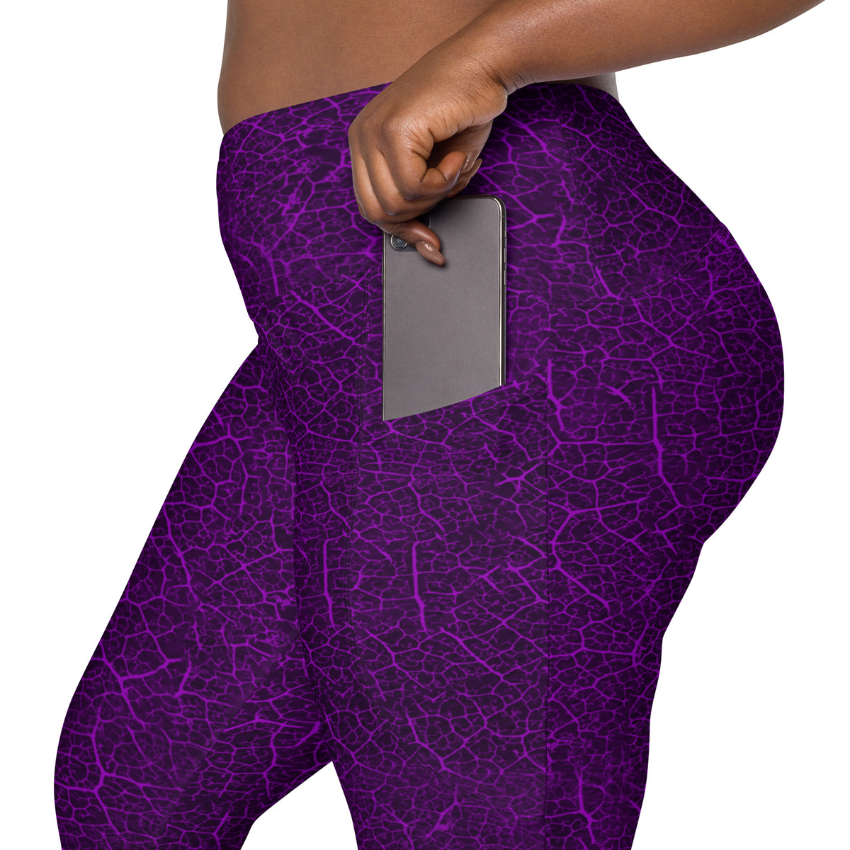 Woman on a serene woodland walk wearing leaf texture leggings with practical pockets.