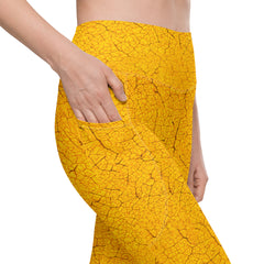 Woman wearing Autumn Elegance leggings with leaf texture, embodying fall chic with practical pockets.