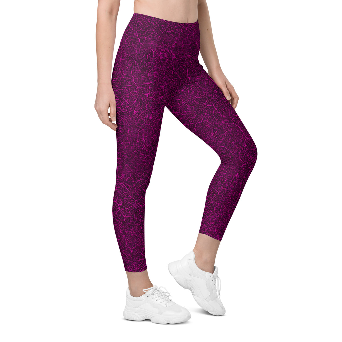 Woman exploring a dewy meadow in leaf texture leggings, featuring stylish and practical pockets.
