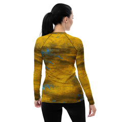 Nature-inspired grass stains on women's rash guard for sports.