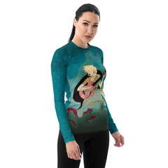 Model Wearing Peaceful Petals Women's Rash Guard on the Beach