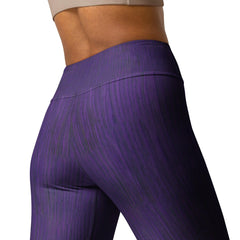 Woman wearing deep purple yoga leggings in a yoga pose.