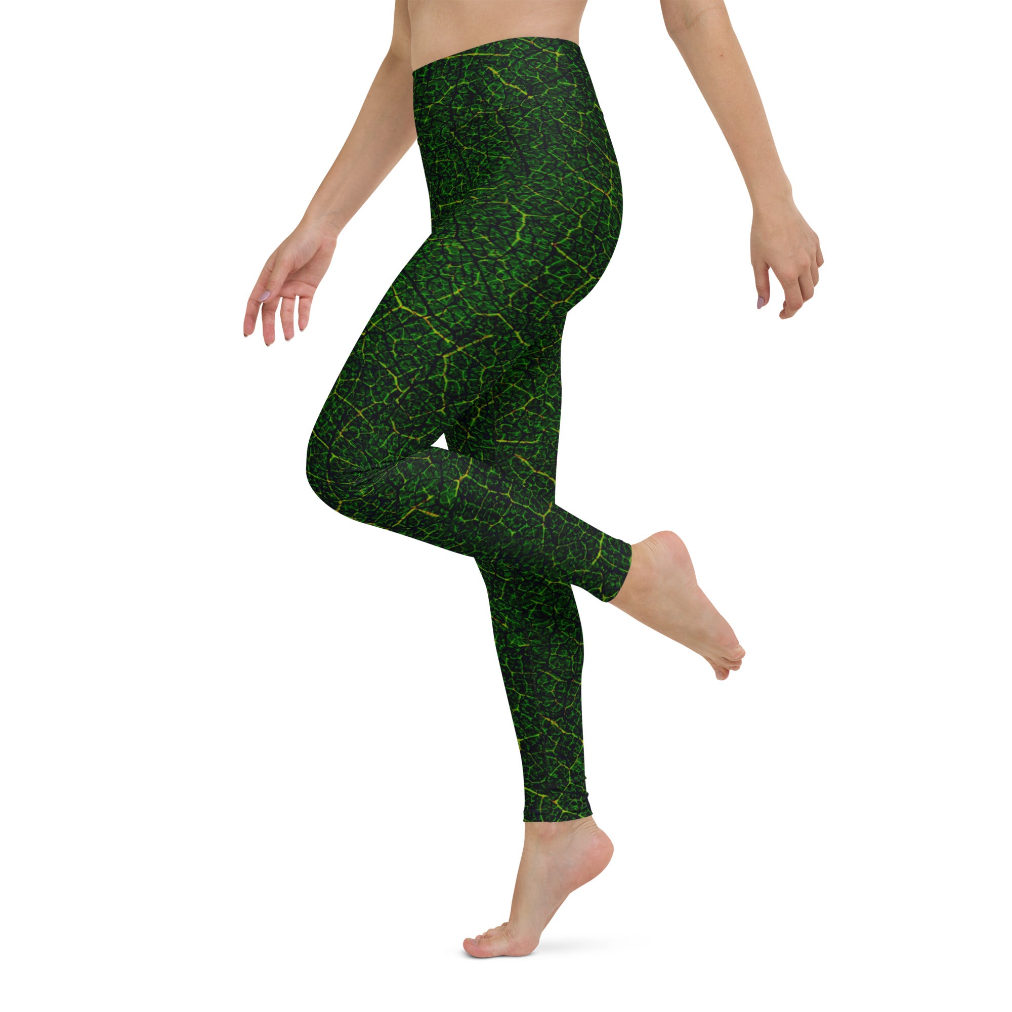 Practicing yoga in Verdant Vines Yoga Leggings, showcasing their vibrant vine design and supportive stretch for flexibility.