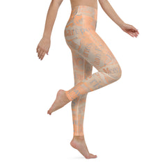 Inked Impressions Yoga Leggings on a model stretching in a yoga studio.