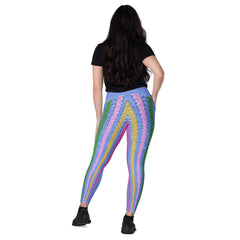 Comfortable crossover leggings with artistic design and pockets, ideal for fitness enthusiasts.