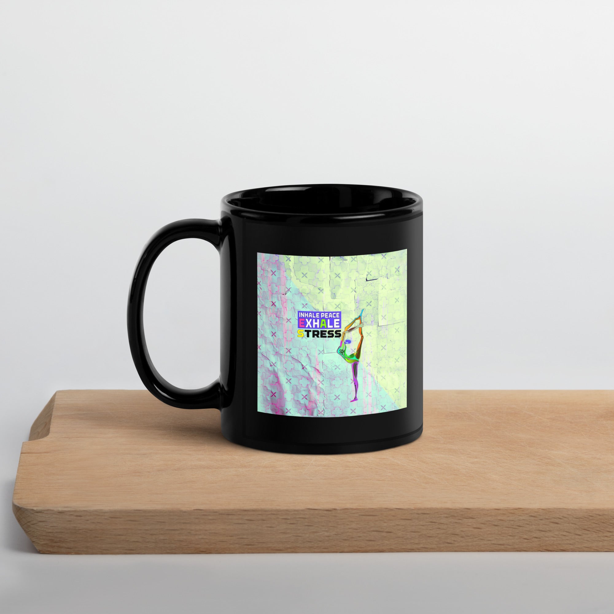 Black glossy mug with Lotus Pose design for serene sipping.