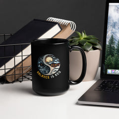 Close-up of Mountain Reflection Yin Yang Design on Black Mug.