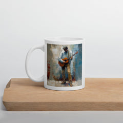 White glossy mug with acoustic guitar emblem for music lovers.