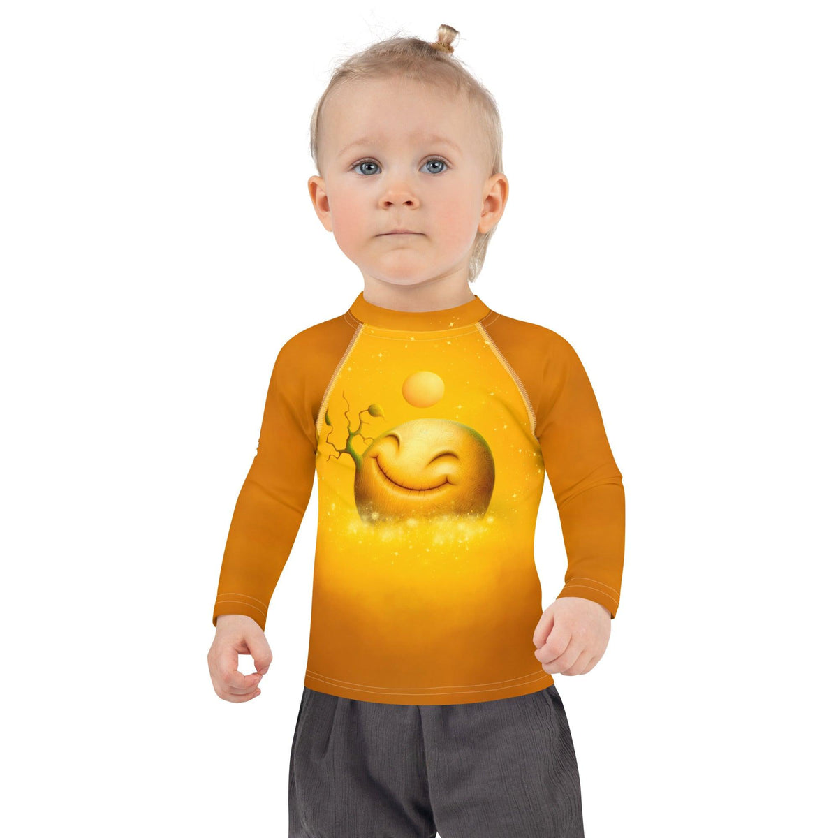 Child wearing Celestial Luna Dreams Kids Rash Guard at the beach.
