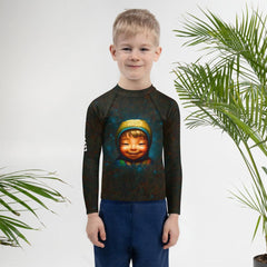 Kid playing in the sand wearing Dreamscape Portraits Rash Guard.